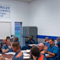 students smiling and clapping in the classroom